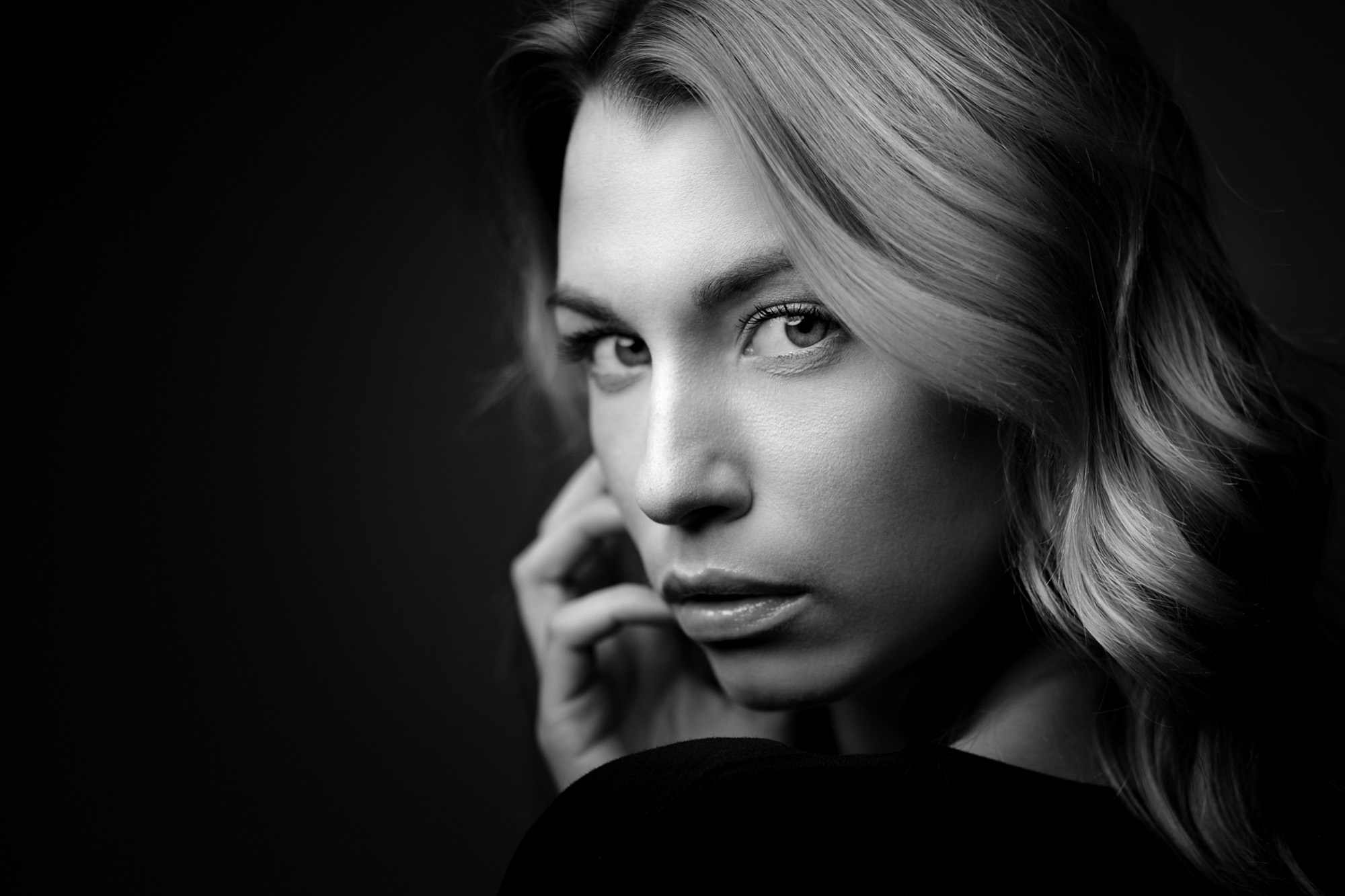 Black and white portrait of a woman looking over her shoulder